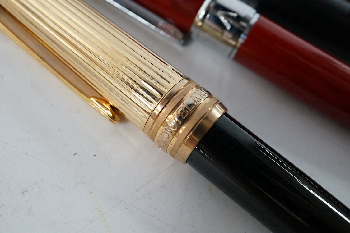 Five pens including a Parker pen with 14k gold nib and four Mont Blanc style pens. Condition - fair